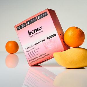 Box of beme Liquid Collagen Peptides with oranges and a mango on a reflective surface