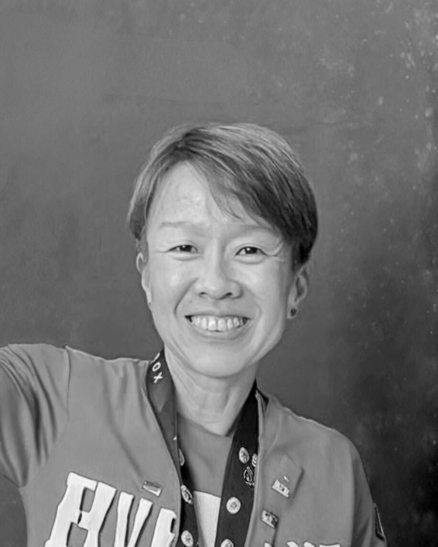Black and white photo of Dr Gan  wearing a jacket.