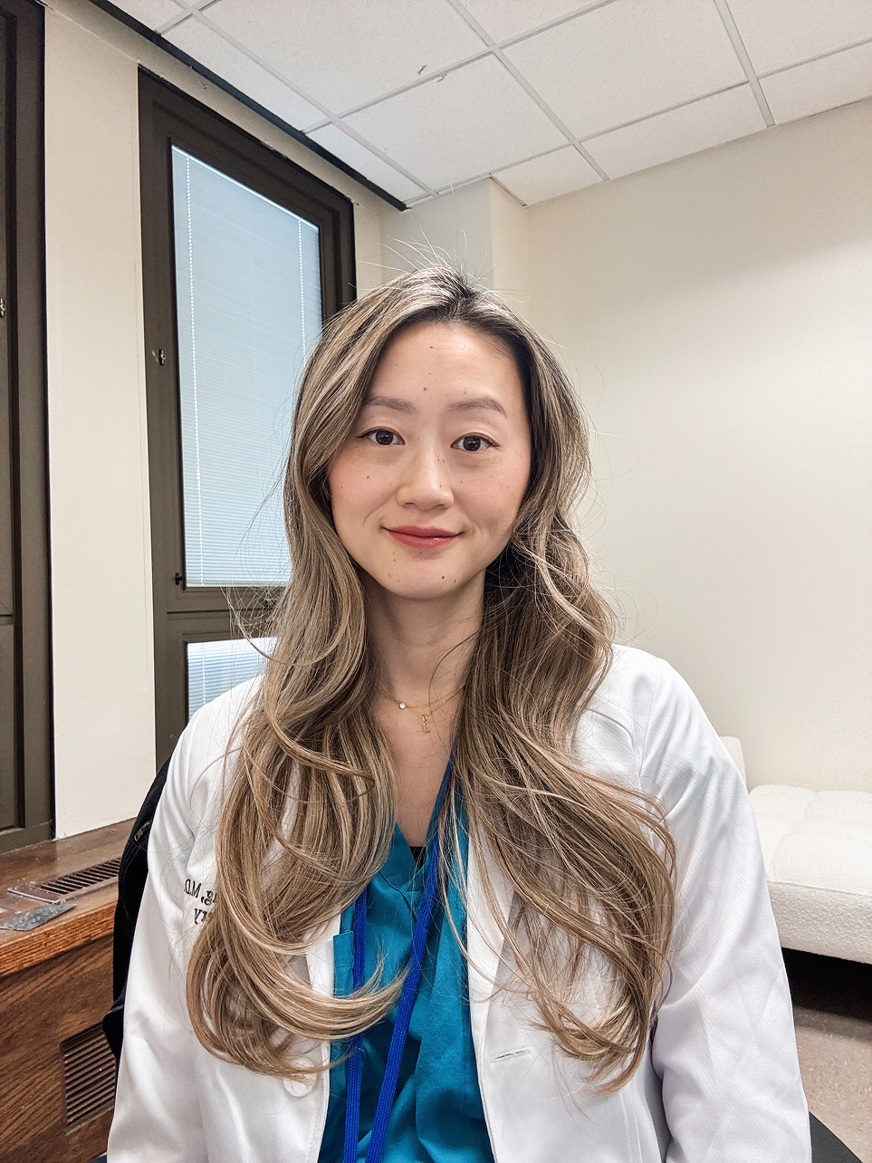 Dr Yang wearing a white coat in an indoor setting
