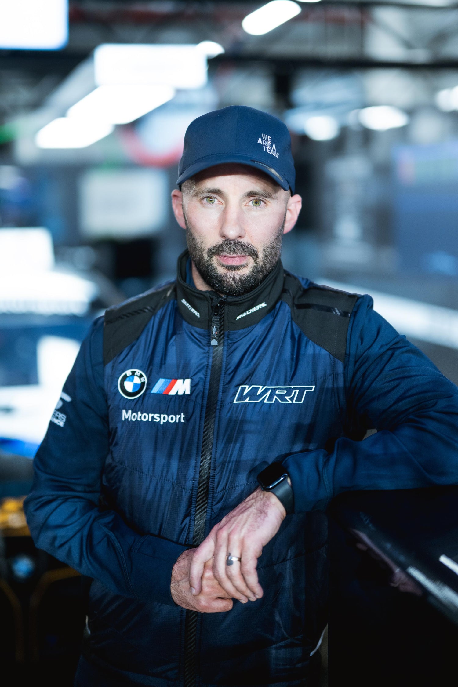 Dr. Daniel wearing a BMW WRT jacket and cap.